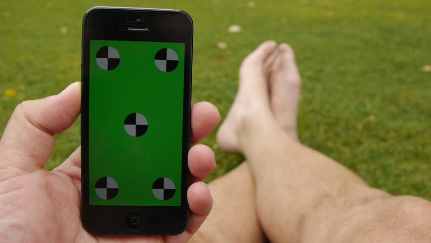 Using A Smart Phone Held Stock Footage 100 Royalty Free Using A Smart Phone Held By Hands While Sitting At The Park Green Screen Chroma Key Close Up Tracking Motion Vertical Tile Floor Grass