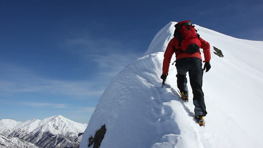 Stock video of mountaineer climbing a snowy ridge in | 5369420 ...