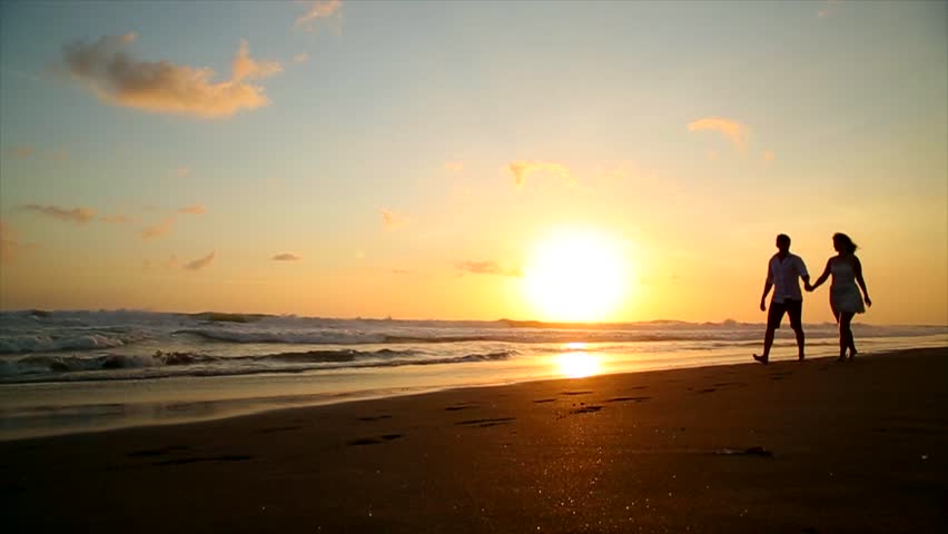 Couple Walking Beach At Sunset