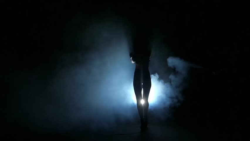 One Sexy Woman Stripper Showgirl In Silhouette Studio Isolated On Dark