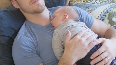 baby sleeping on dads chest