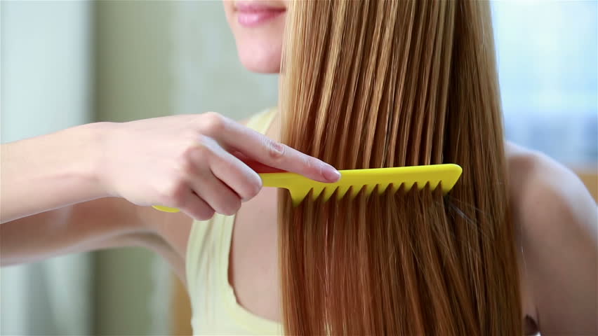 Young Beautiful Woman With Long Red Hair Uses A Curling 